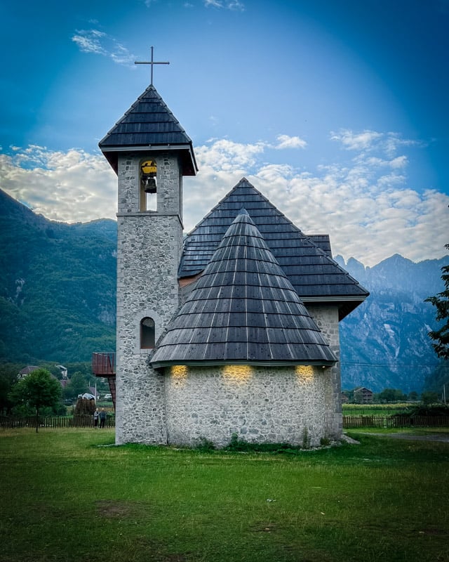 A picturesque church in Theth nestled between rocky mountains