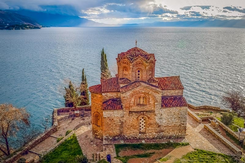 St. John the Theologian (Kaneo) in Ohrid with lake and mountain views.