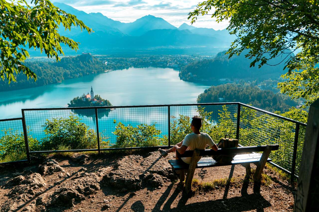 A person siting on a bench at Mala Osojnica in Lake Bled