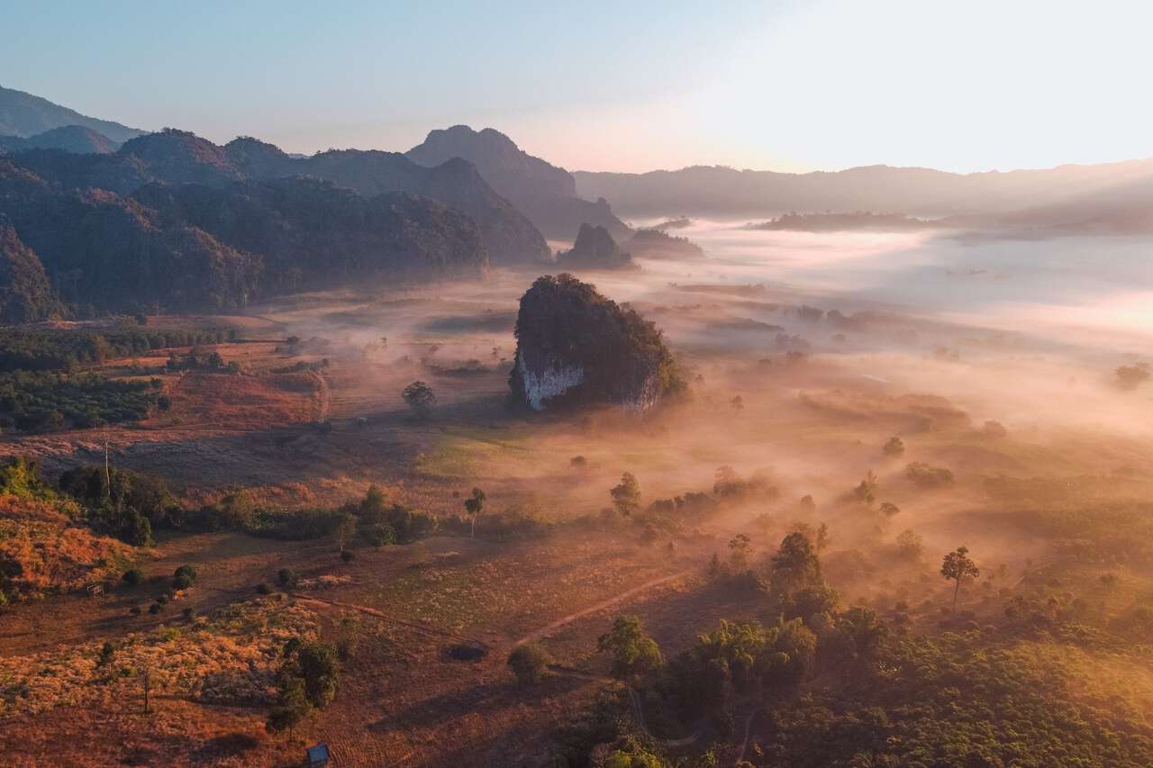 An aerial shot of the sea of clouds at sunrise in Phu Langka, Phayao